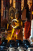 Chiang Mai - The Wat Phan Tao temple, Inside the Wihan: the 108 alm bowls for collecting the offers of coins.  